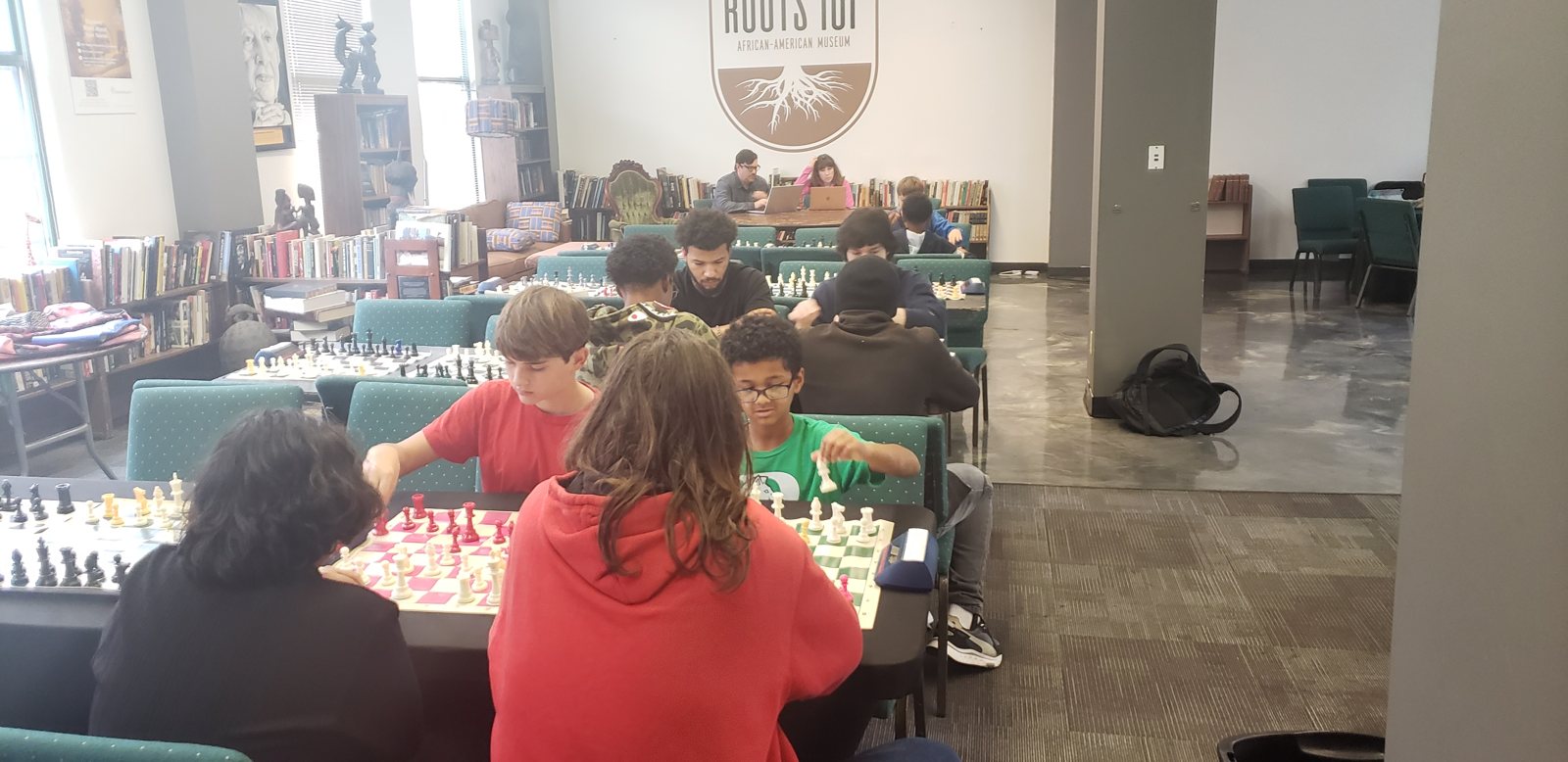 Players settle in at the long tables, Butch Mosby Chess Classic 2 at Roots 101 African American Museum, Louisville
