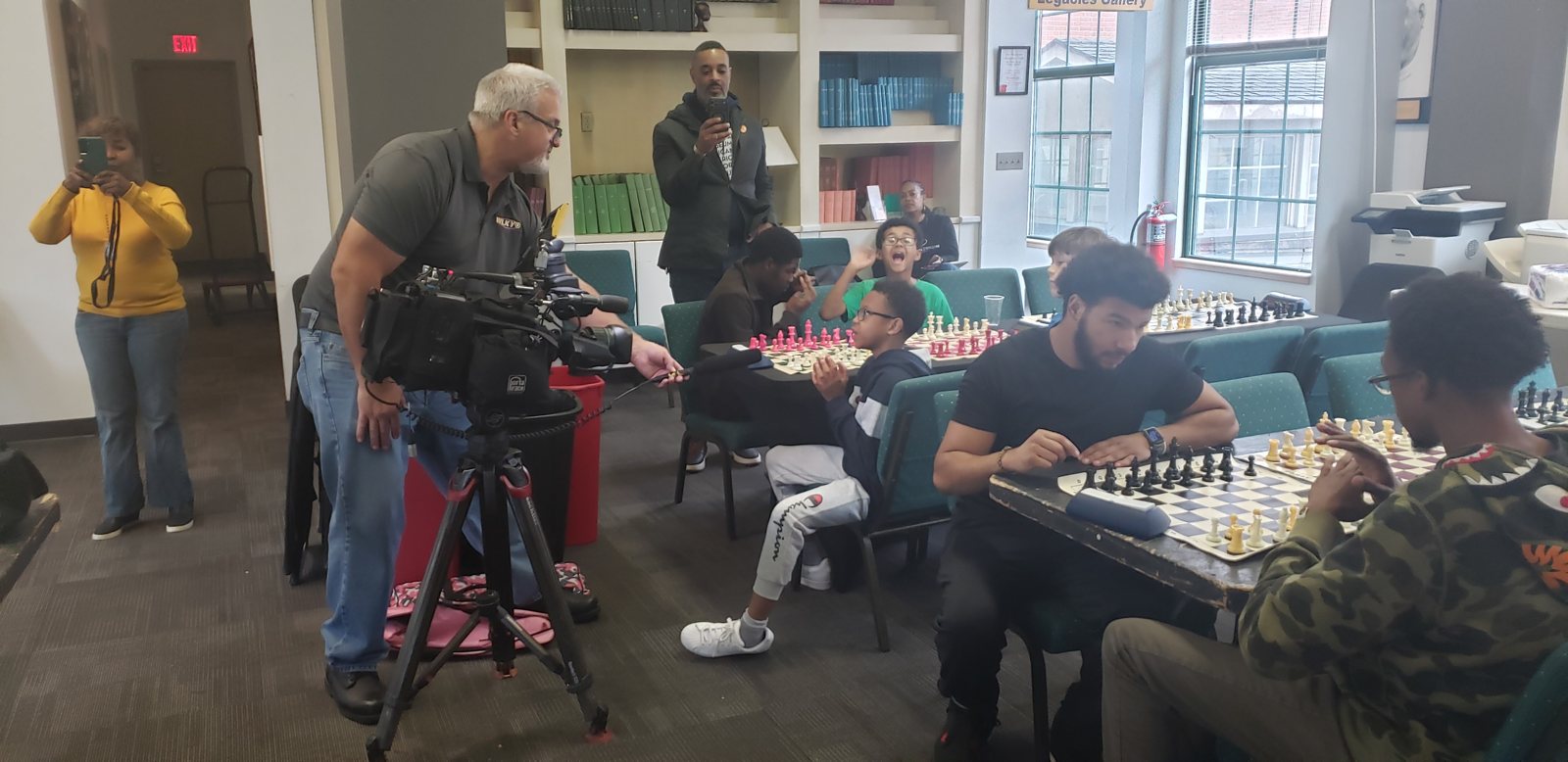 A TV news crew covers the tournament, Butch Mosby Chess Classic 2 at Roots 101 African American Museum, Louisville