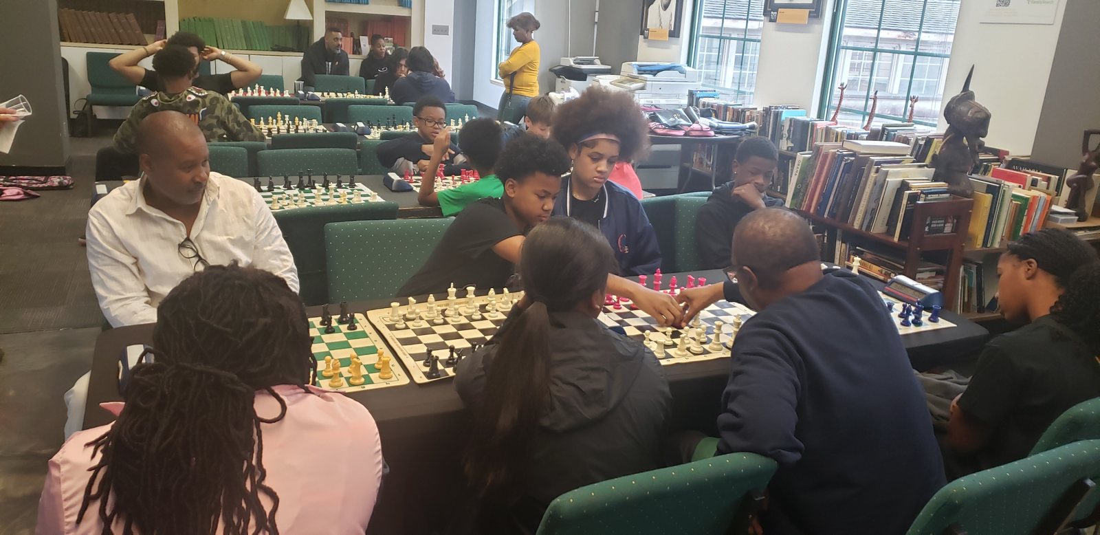 Players and spectators around a board, Butch Mosby Chess Classic 2 at Roots 101 African American Museum, Louisville